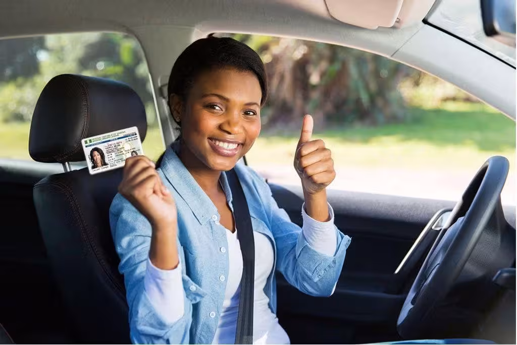 woman getting driver license thumb up